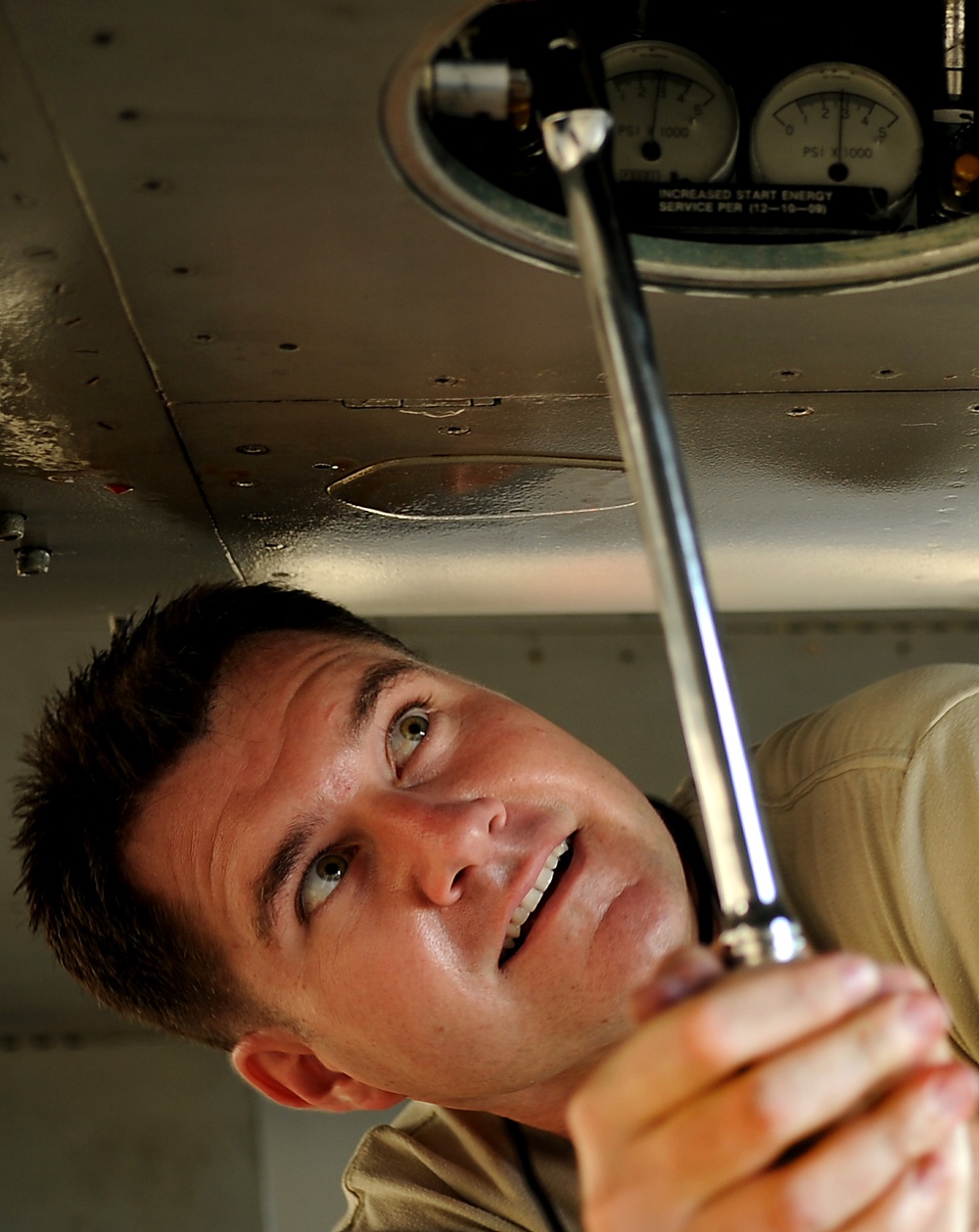 Master Sgt. John Bell pumps a jet fuel starter on an F-15 Eagle aircraft.