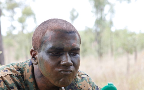 Lance Cpl. Michael Ellmer applies camouflage paint during Exercise Hamel 2010.