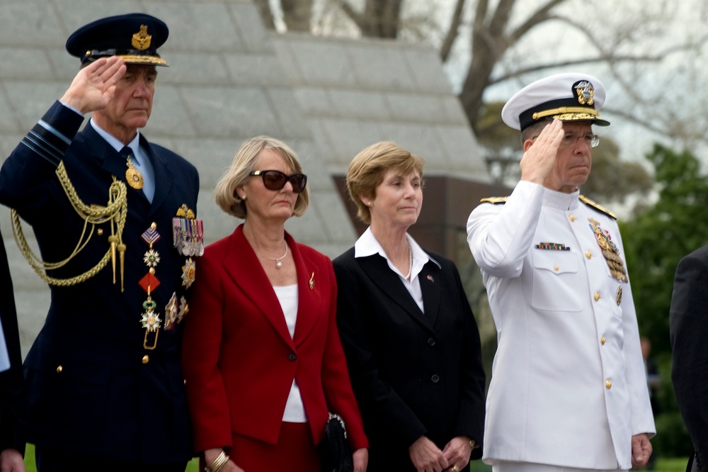Adm. Mike Mullen salutes during a wreath laying ceremony.