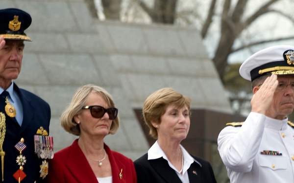 Adm. Mike Mullen salutes during a wreath laying ceremony.