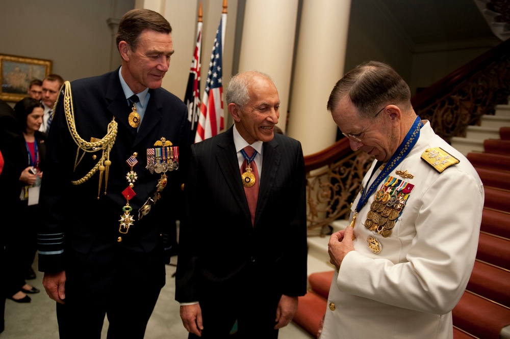 Air Chief Marshal Angus Houston and David de Kretser admire the Officer of the Order of Australia presented to Adm. Mike Mullen. Air Chief Marshal Angus Houston and David de Kretser admire the Officer of the Order of Australia presented to Adm. Mike Mullen.