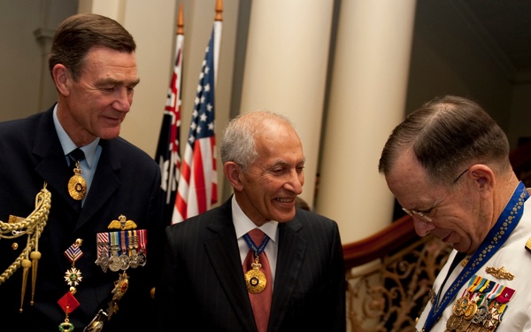 Air Chief Marshal Angus Houston and David de Kretser admire the Officer of the Order of Australia presented to Adm. Mike Mullen.