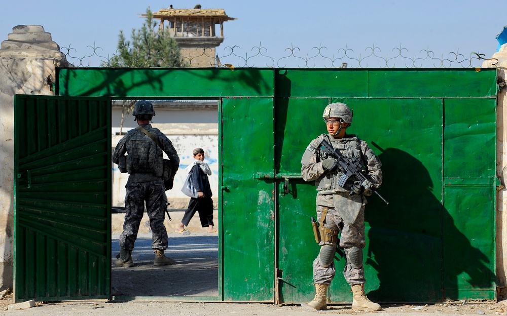 Pfcs. Nicholas Sudano and Nicholas Querzoli secure the gate to the construction site.