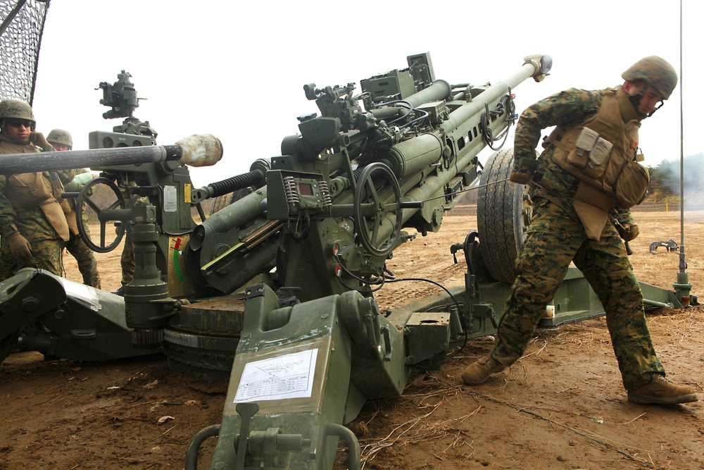 Gun Team Five fires a round from a M777A2 howitzer at Camp Sendai.