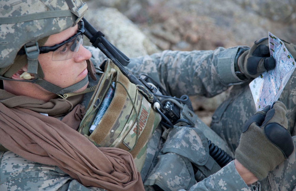 U.S. Army 2nd Lt. Aaron M. Dunson reads a map at a rally point in Konar province.