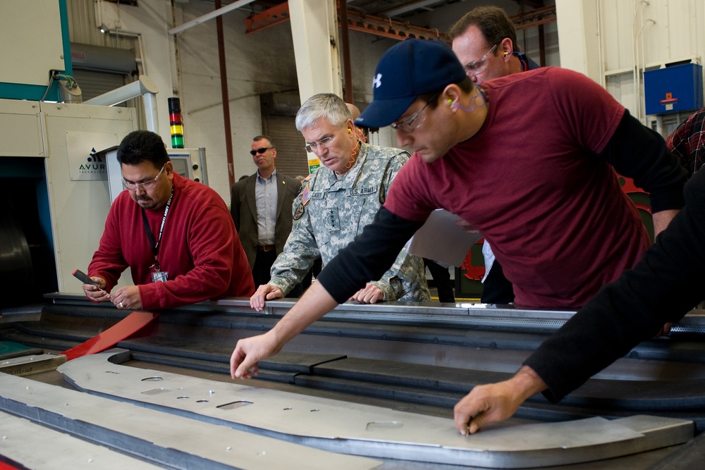 Gen. George W. Casey Jr. observes how UH-60 Blackhawk helicopter parts are molded.