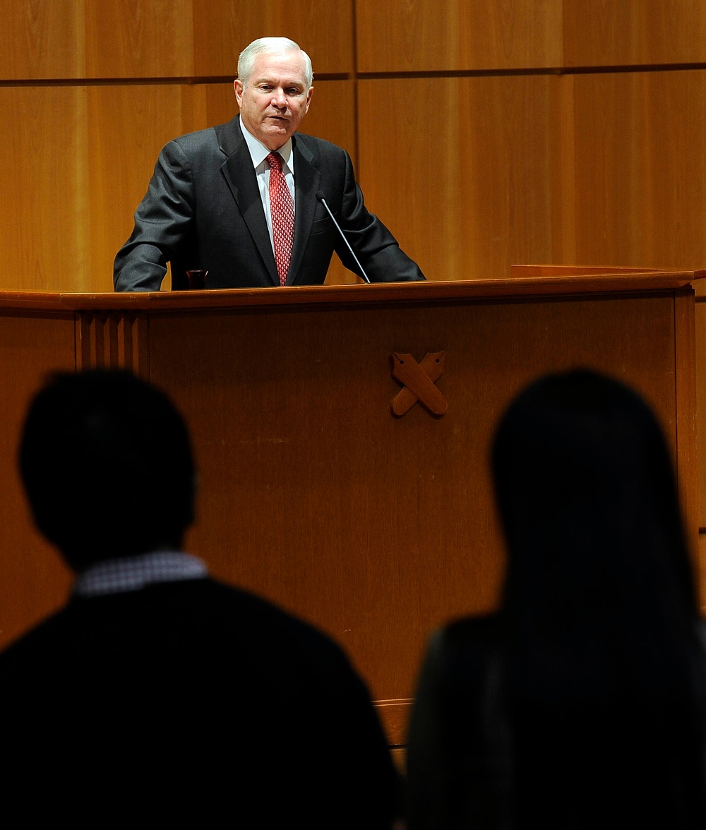 Secretary Gates listens to a student's question after giving a speech.