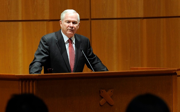 Secretary Gates listens to a student's question after giving a speech.