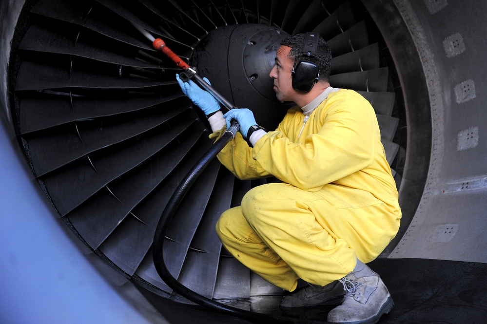 Staff Sgt. Luis Mejias inspects and washes the blades of a C-17 Globemaster III aircraft.