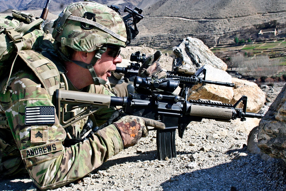 Sgt. Nick Andrews looks from a ridge into the town of Tupac.