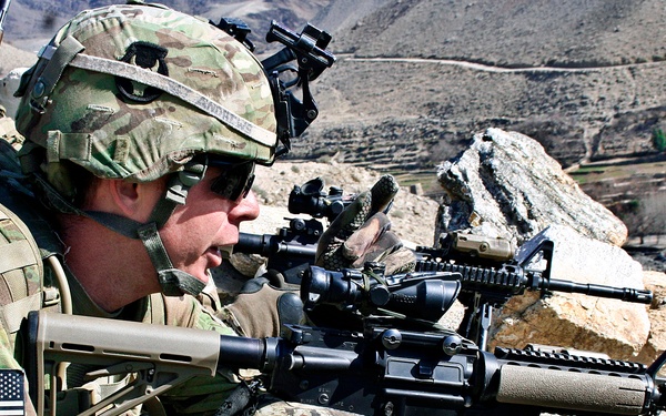 Sgt. Nick Andrews looks from a ridge into the town of Tupac.