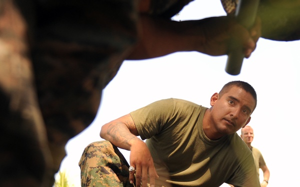 Gunnery Sgt. Joe Urias observes as Guatemalan marines perform takedown techniques.