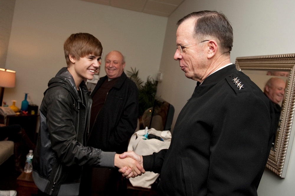 Adm. Mike Mullen greets pop star Justin Bieber prior to an appearance on The Daily Show.