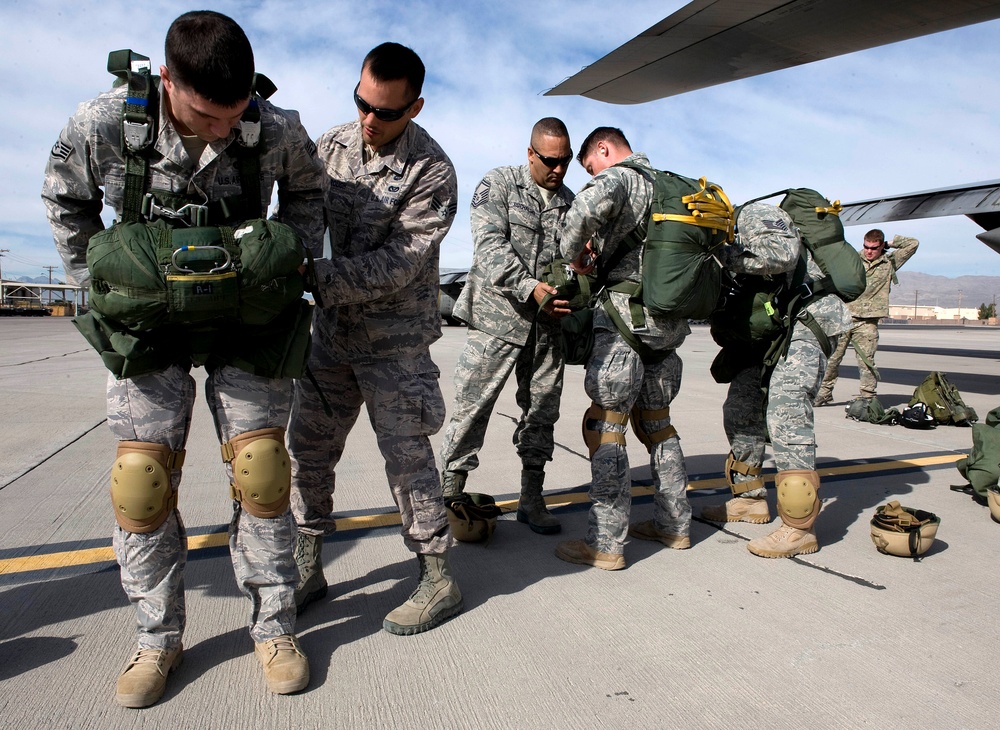 U.S. Air Force airborne jumpers perform buddy checks on each other.