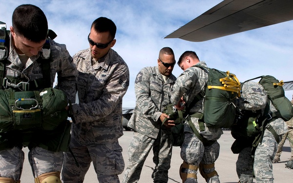 U.S. Air Force airborne jumpers perform buddy checks on each other.