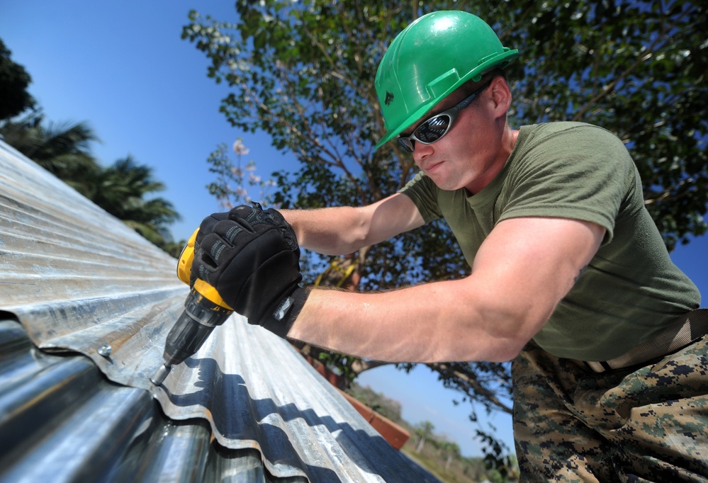 Lance Cpl. Stephen S. Mcdonaldhale repairs the roof of a classroom at Escuela Santa Marta.
