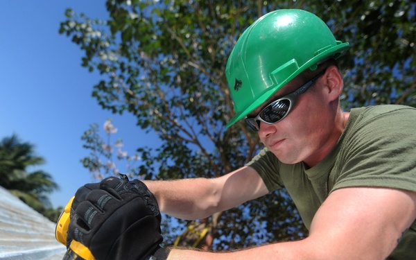 Lance Cpl. Stephen S. Mcdonaldhale repairs the roof of a classroom at Escuela Santa Marta.