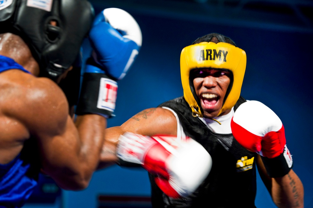 Spc. Zacchaeus Hardrick punches Air Force Staff Sgt. Gary Griffin during their bout.
