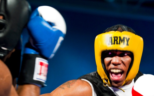 Spc. Zacchaeus Hardrick punches Air Force Staff Sgt. Gary Griffin during their bout.