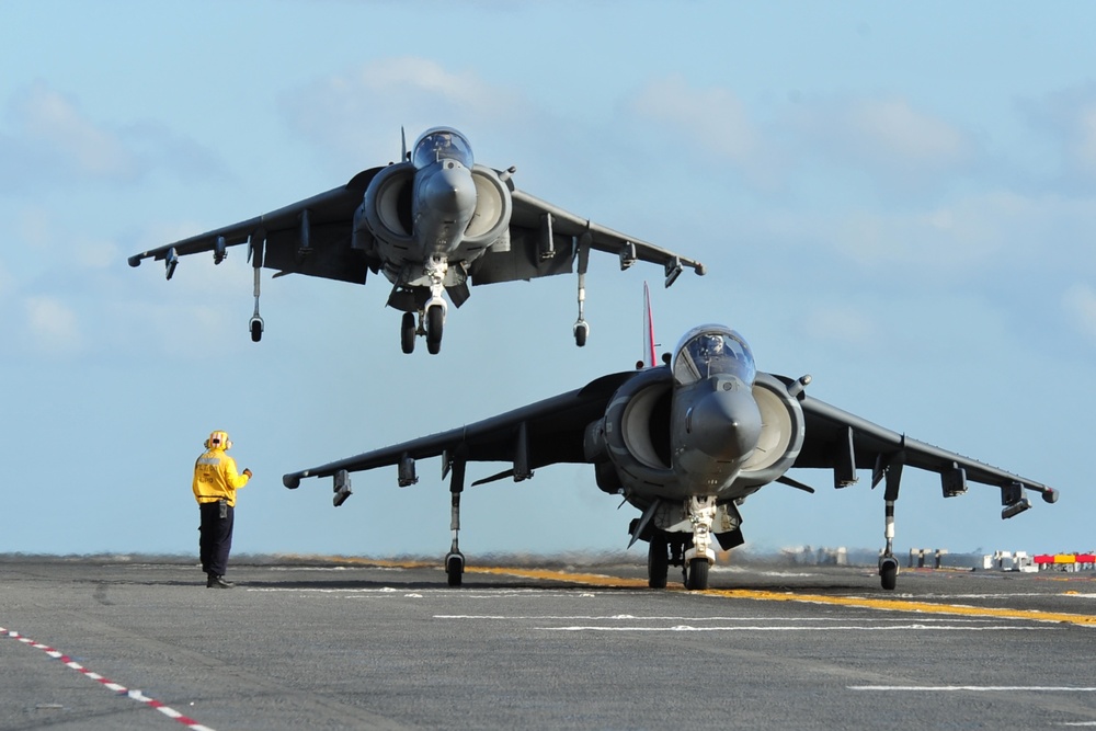 An AV-8B Harrier prepares for takeoff as another lands.