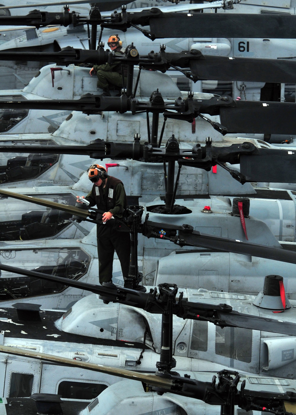 Marines conduct routine maintenance on helicopters assigned to Marine Medium Squadron 163.