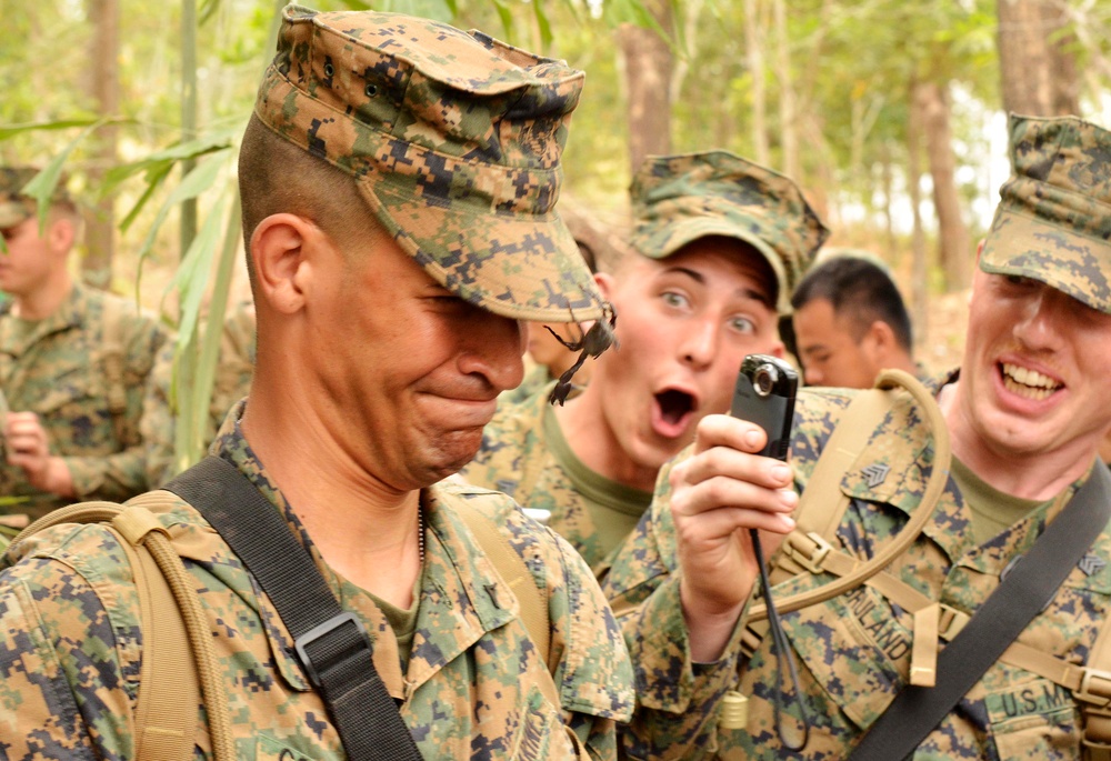Lance Cpl. Miguel Gonzalez closes his eyes as a scorpion crawls on his cover.
