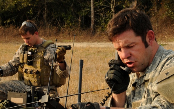 U.S. Army soldiers call in an operation schedule.