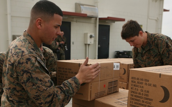 U.S. Marines load food onto a cargo platform to deliver to Japanese residents.