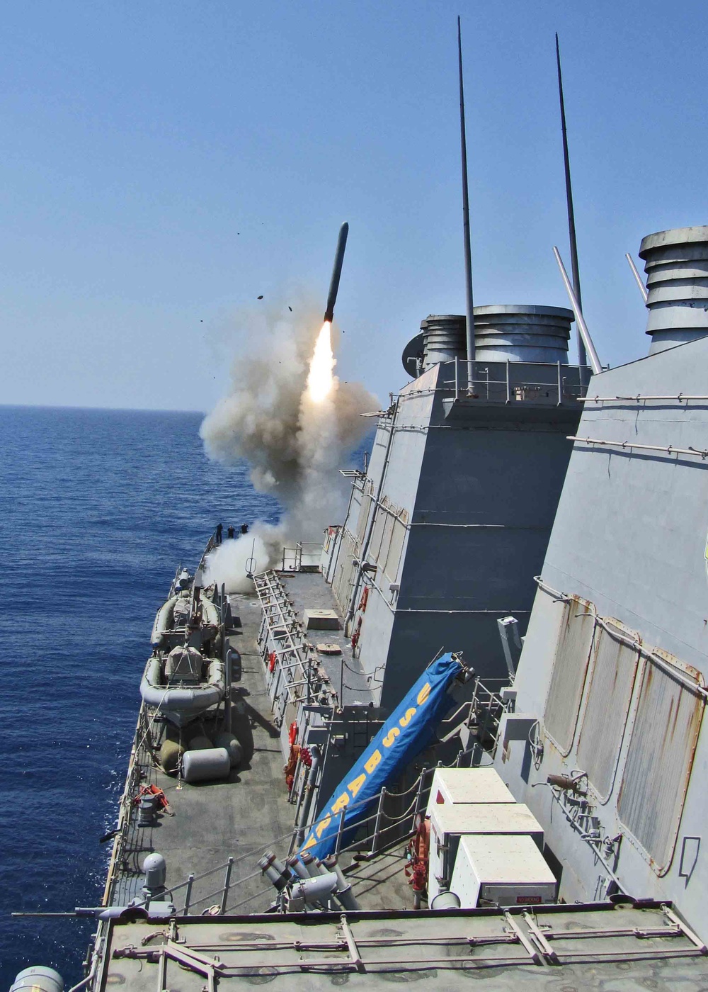 The guided-missile destroyer USS Barry (DDG 52) launches a Tomahawk cruise missile.