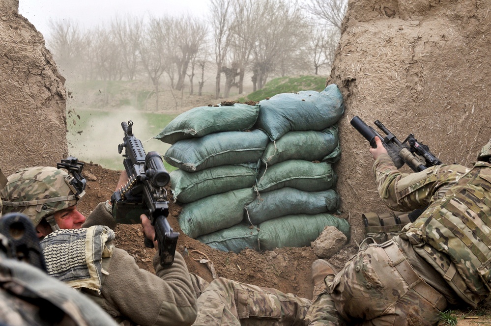Pfc. Ben Bradley ducks away from small-arms fire.