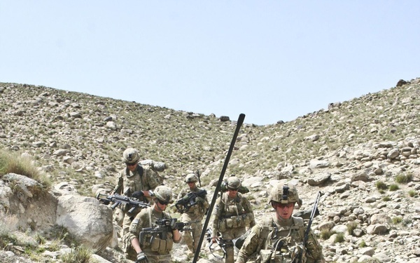 U.S. Army 2nd Lt. Taylor Gingrich takes a breather after descending a mountain ridge.