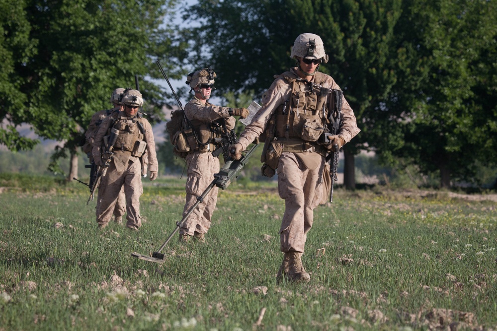 Cpl. Ben W. Gibson sweeps for explosive devices with a metal detector. Cpl. Ben W. Gibson sweeps for explosive devices with a metal detector.