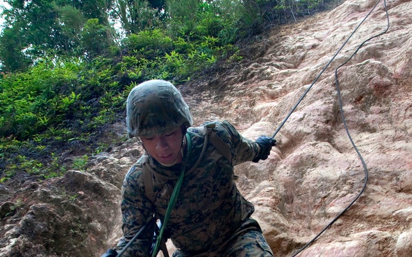 A U.S. Marine participates in the endurance course at the Jungle Warfare Training Center.