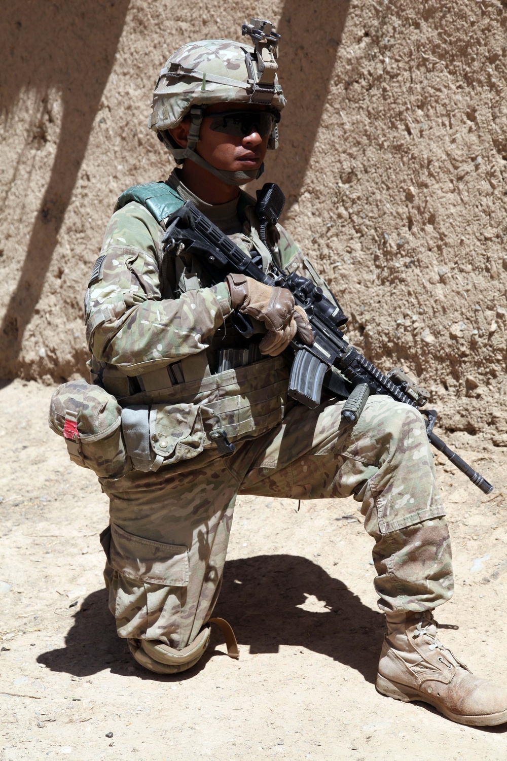 Sgt. Christopher Tagoon takes a knee while providing security.