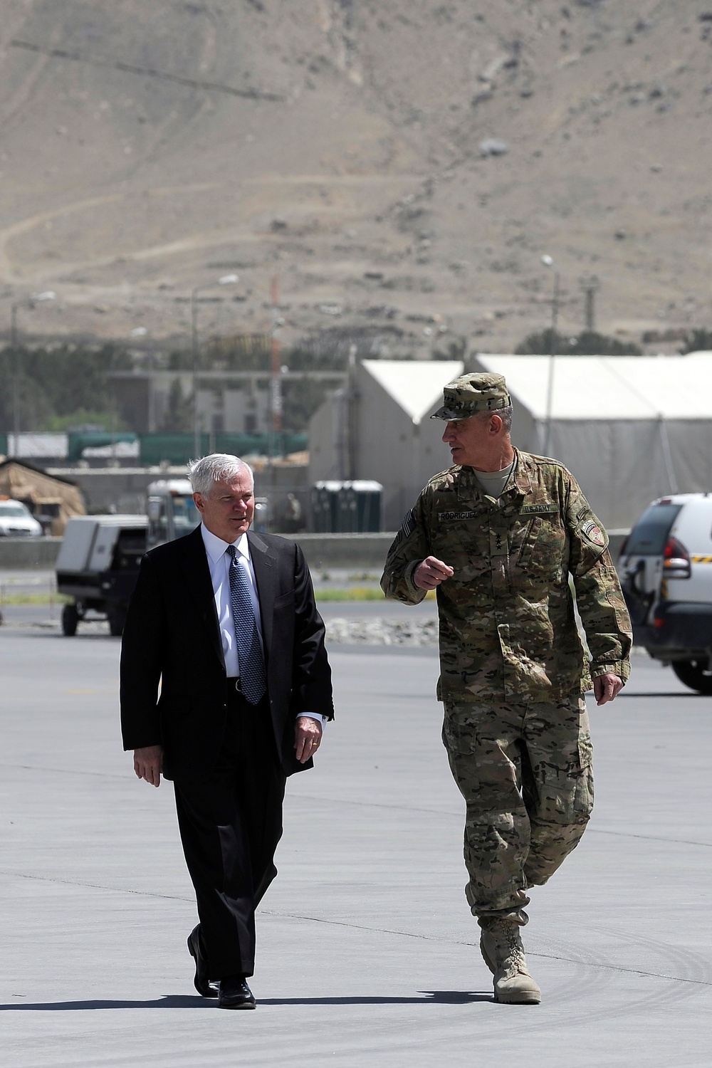 Secretary Gates and Lt. Gen. David M. Rodriguez walk to the aircraft at the Kabul airport.
