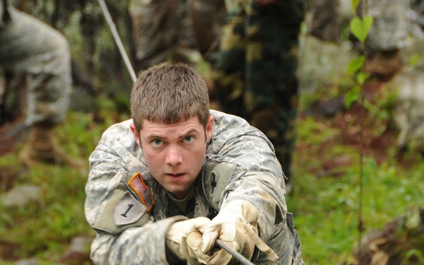 Sgt. Johnathan Oberholz crosses a one-rope bridge during an infantry subject matter expert exchange.