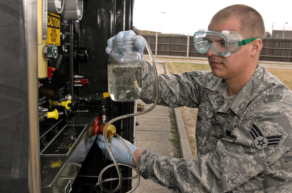 Senior Airman Justin Gilbert collects a fuel sample for testing at Royal Air Force Lakenheath.