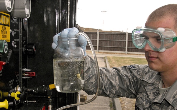 Senior Airman Justin Gilbert collects a fuel sample for testing at Royal Air Force Lakenheath.