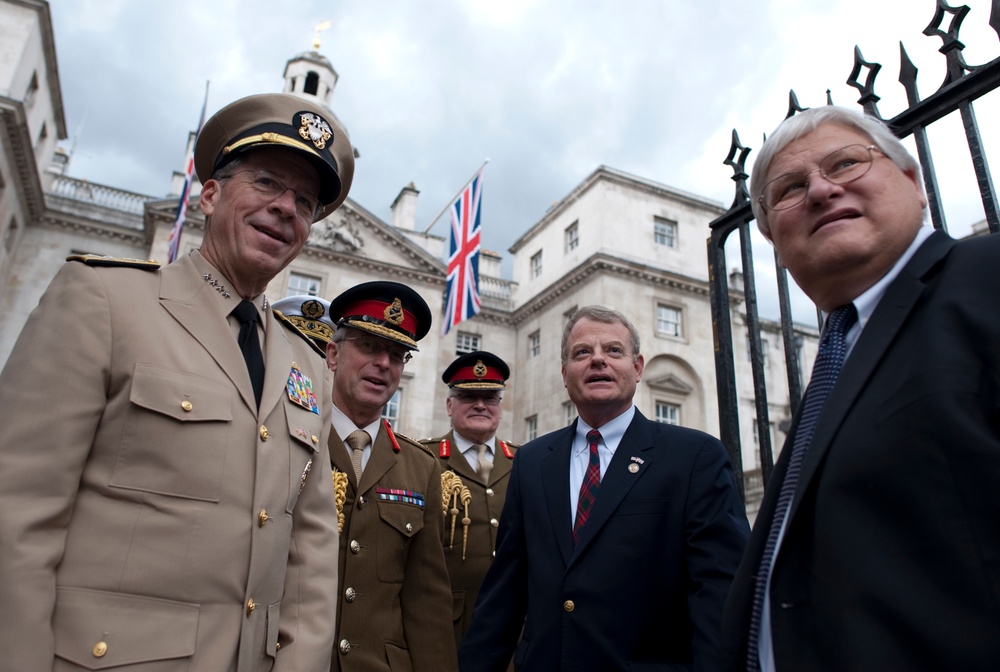 Adm. Mike Mullen and British Chief of Defense Staff Gen. Sir David Richards pose for photos with U.S. Congressman Mike McIntyre and Kenny Marchant.