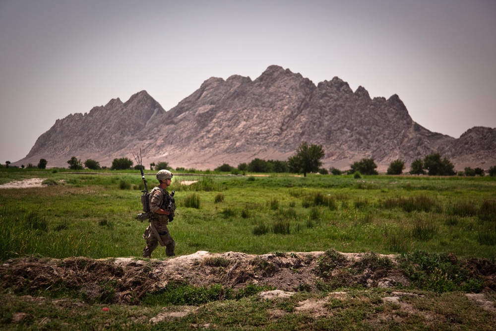 A U.S. Army soldier walks through a valley during a patrol near Malajat.