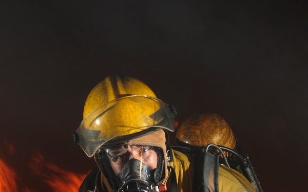 Petty Officer 1st Class Hector Floresdiaz demonstrates firefighting techniques to students.