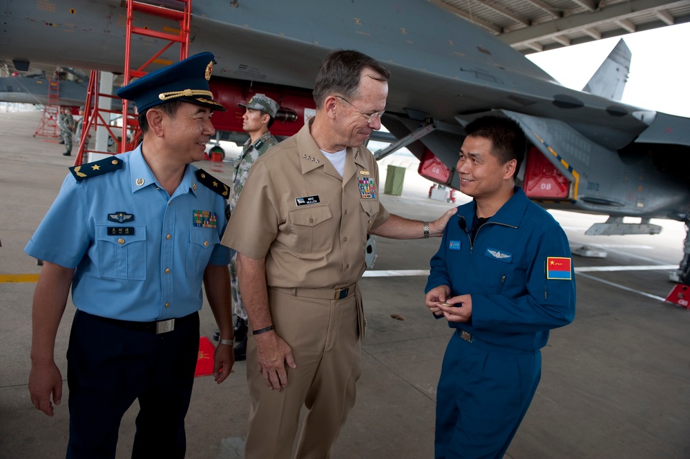 Adm. Mike Mullen thanks a Chinese People's Liberation Army Air Force airman after a tour.