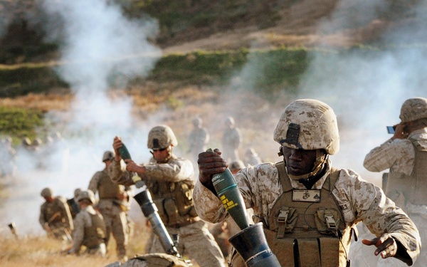 Cpl. Jesse Williamsloads an M252 mortar during a training exercise.