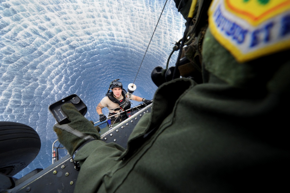 Air Force Pararescueman Staff Sgt. Jacob Schaumberg is hoisted up to an HH-60
