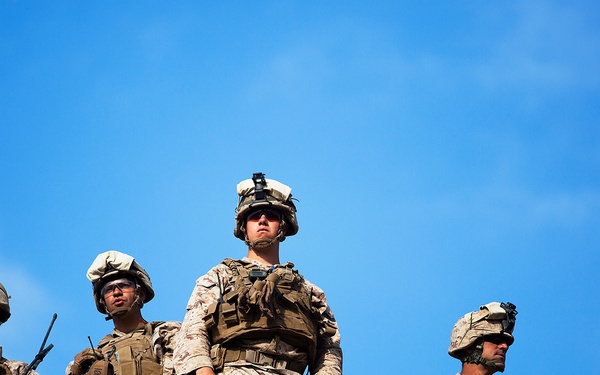 U.S. Marines with the 3rd Battalion watch Marines maneuver through a company attack