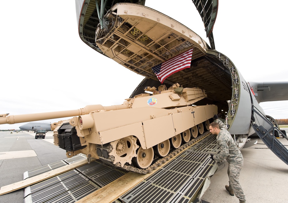 Airmen load a tank into a C-5M Super Galaxy at Dover Air Force Base, Del.
