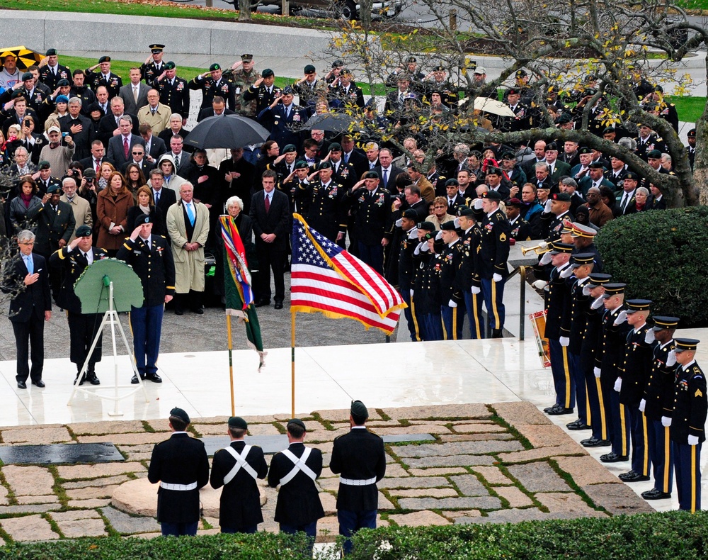 U.S. Army soldiers of the 3rd U.S. Infantry Regiment (The Old Guard) render honors during the playing of Taps at a wreath laying ceremony at the grave site of President John F. Kennedy.
