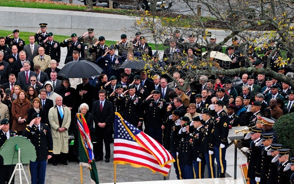 U.S. Army soldiers of the 3rd U.S. Infantry Regiment (The Old Guard) render honors during the playing of Taps at a wreath laying ceremony at the grave site of President John F. Kennedy.