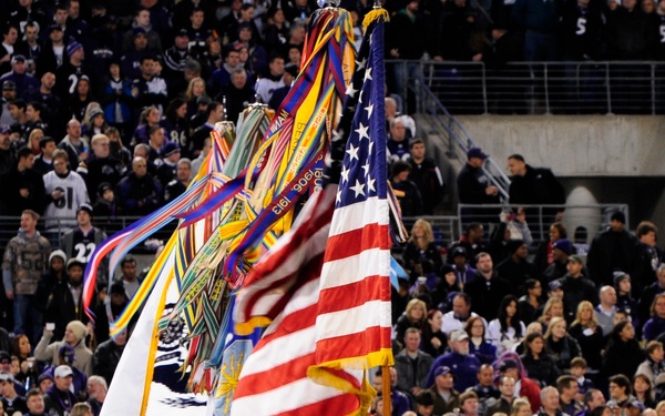 U.S. Army soldiers with the Continental Color Guard, 3rd U.S. Infantry Regiment (The Old Guard) march on to the football field.