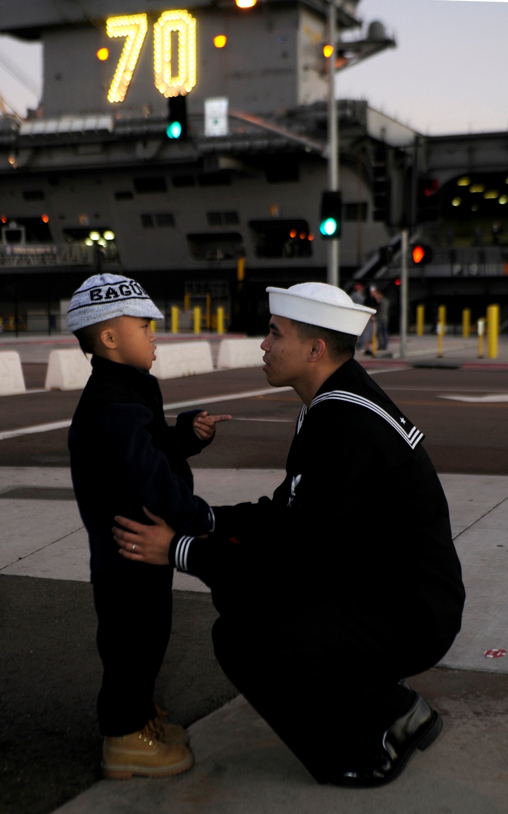Petty Officer 3rd Class Teejay Sunglao says goodbye to his son.
